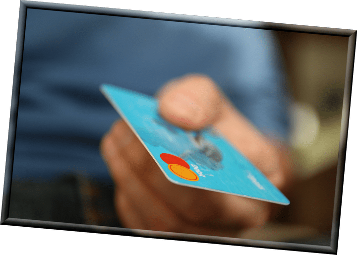 An image of a hand holding a credit card