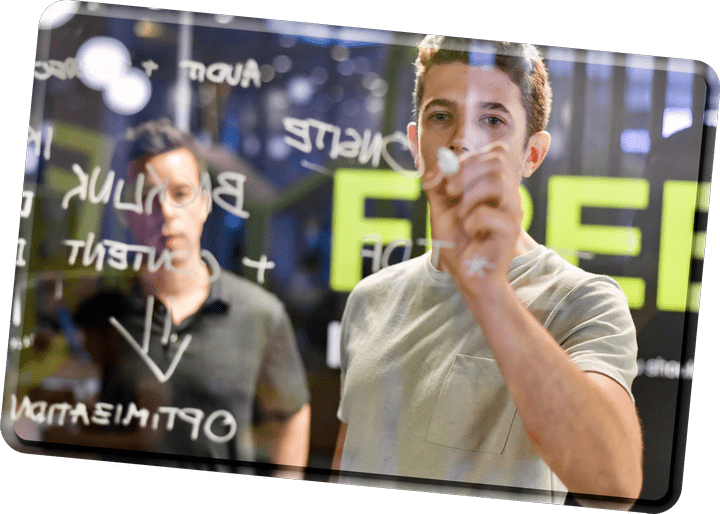 An image of a guy writing on a window